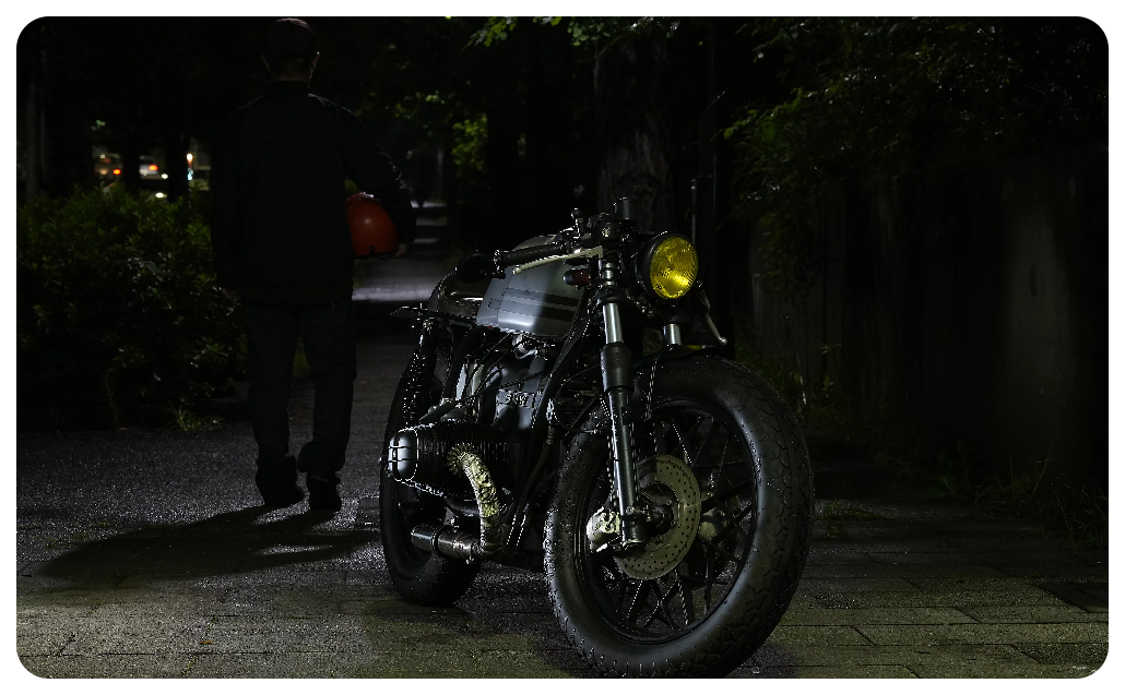 Sony A7 IV Sample photo of bobber style motorcycle with yellow headlight in a dimly lit alleyway